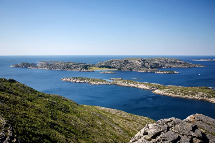 Küstenlandschaft mit felsigen Inseln und blauem Meer unter klarem Himmel